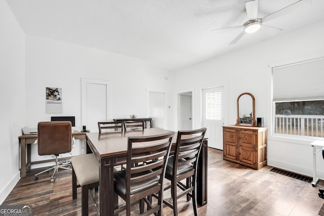 dining area with wood-type flooring and ceiling fan