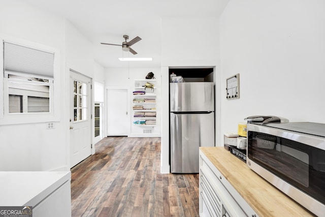 kitchen featuring white cabinetry, dark wood-type flooring, ceiling fan, and appliances with stainless steel finishes