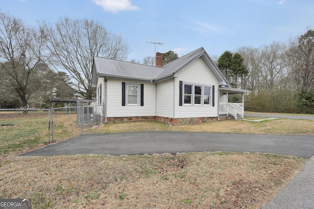 view of side of home with a yard