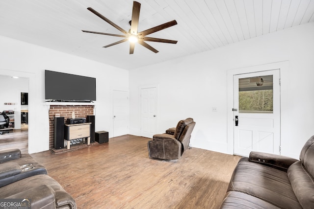 living room with hardwood / wood-style flooring, ceiling fan, and wooden ceiling