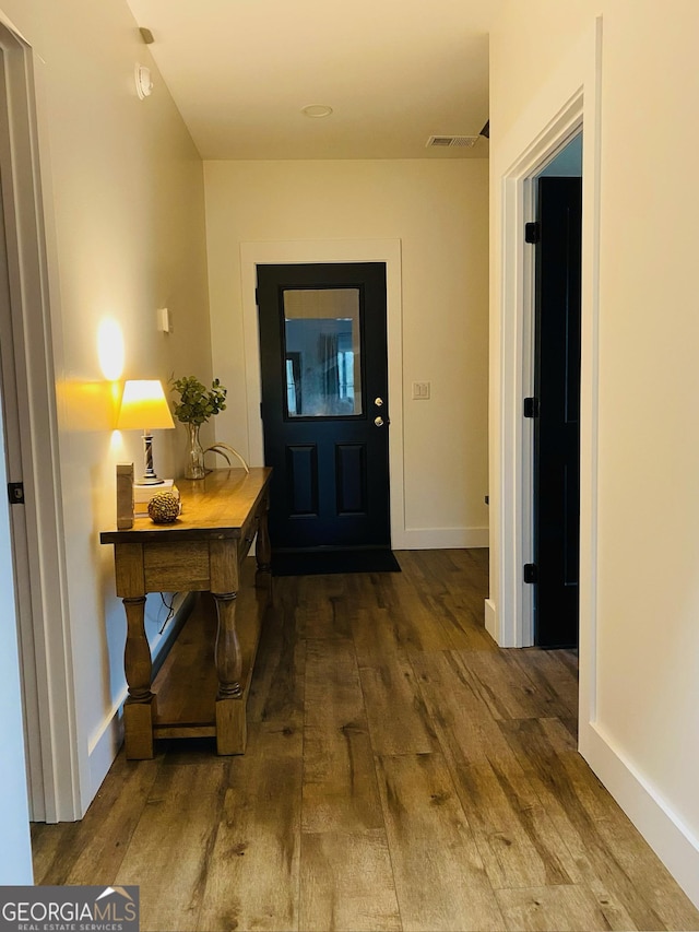 corridor featuring wood-type flooring