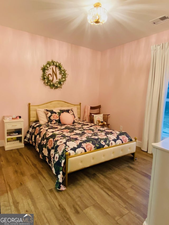 bedroom with hardwood / wood-style floors