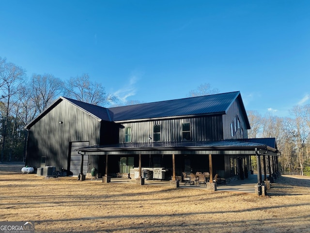 rear view of property with central AC and a patio area