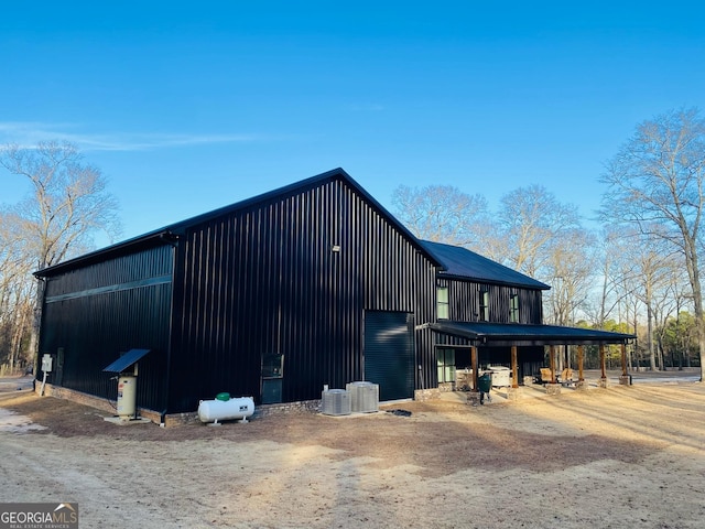 view of side of home featuring an outbuilding and central air condition unit