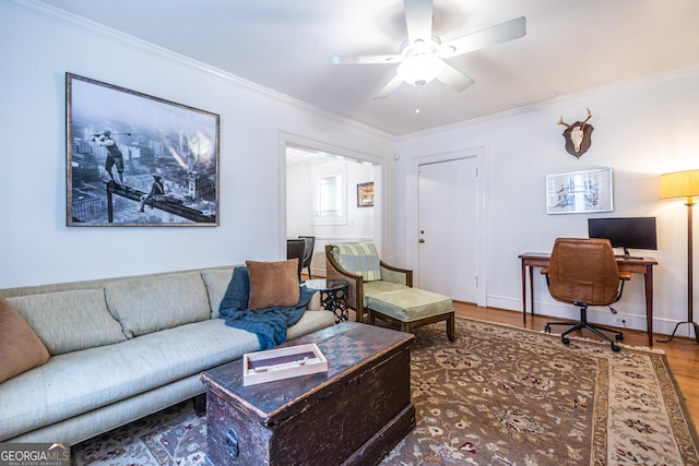 living room with crown molding, wood-type flooring, and ceiling fan