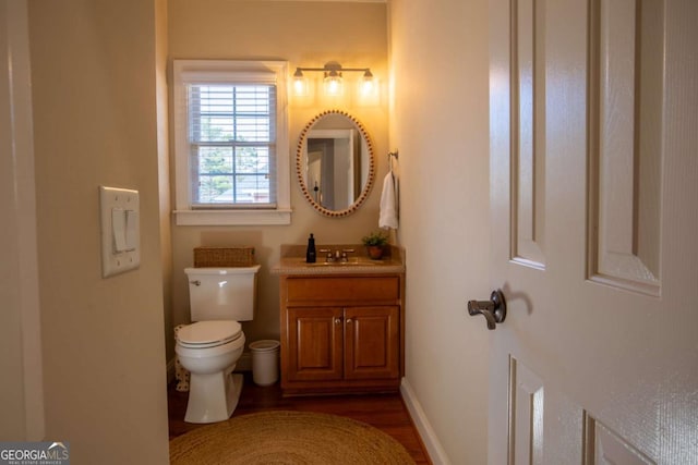 bathroom featuring vanity, hardwood / wood-style floors, and toilet