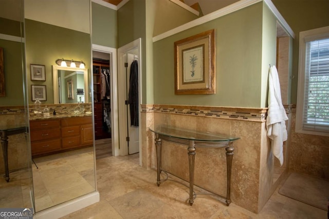 bathroom featuring vanity and tile walls