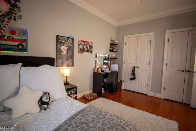 bedroom with crown molding and dark hardwood / wood-style floors