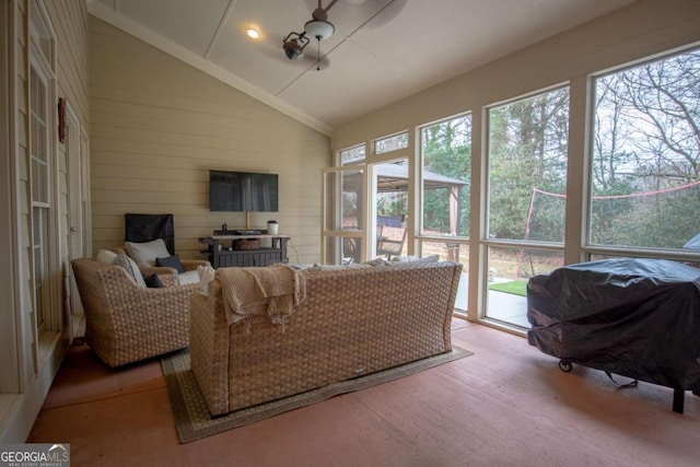 sunroom featuring lofted ceiling and a healthy amount of sunlight