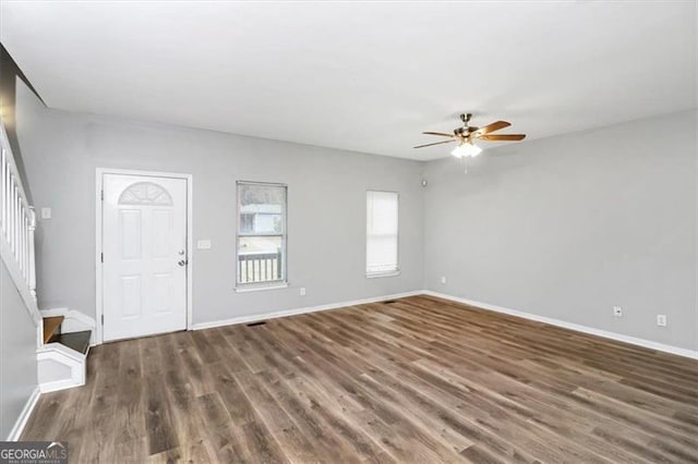 foyer featuring dark wood-type flooring and ceiling fan