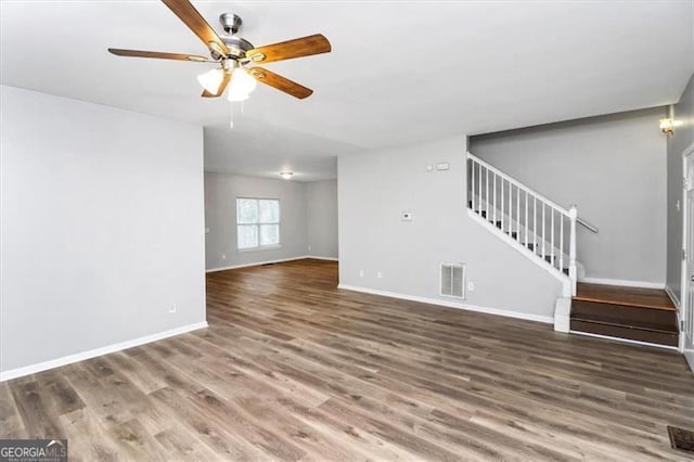 unfurnished living room with ceiling fan and dark hardwood / wood-style floors