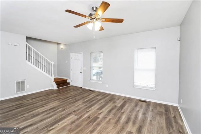 unfurnished living room with dark hardwood / wood-style floors and ceiling fan