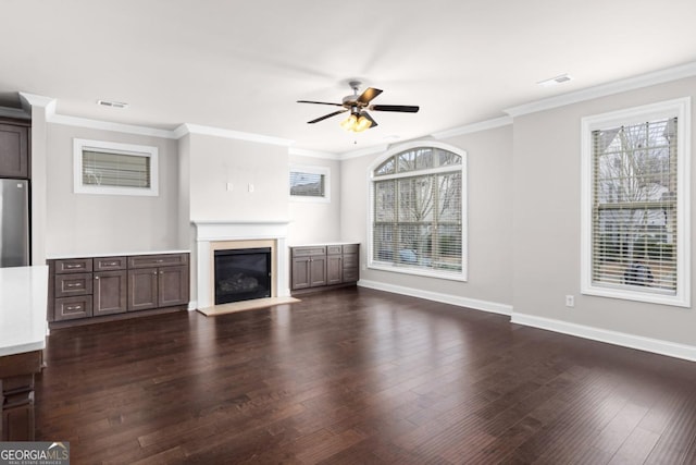 unfurnished living room with ornamental molding, dark hardwood / wood-style floors, and ceiling fan