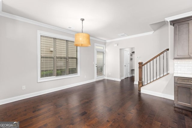 foyer with ornamental molding and dark hardwood / wood-style flooring