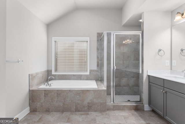 bathroom with vanity, vaulted ceiling, and shower with separate bathtub