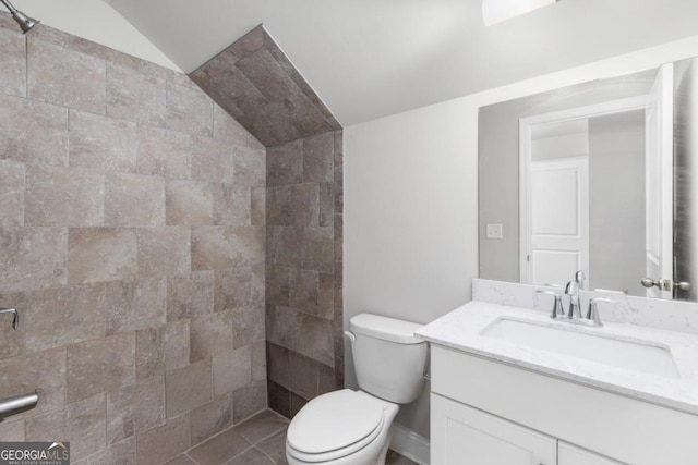 bathroom with vanity, vaulted ceiling, and toilet