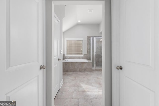 hallway featuring vaulted ceiling