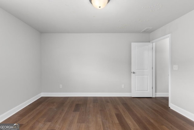 unfurnished room featuring dark hardwood / wood-style floors