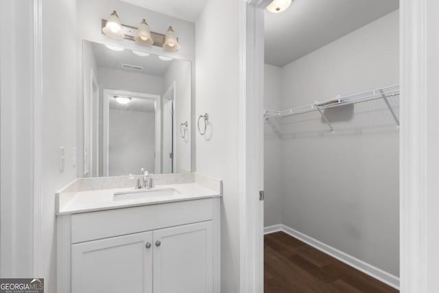 bathroom with hardwood / wood-style flooring and vanity