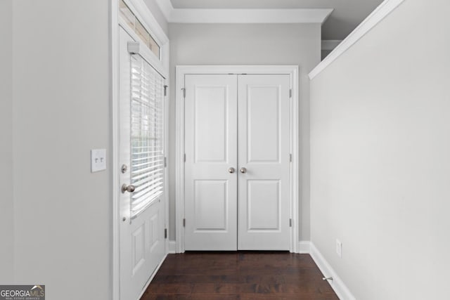 doorway featuring dark hardwood / wood-style flooring and ornamental molding