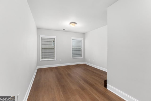 unfurnished room with wood-type flooring