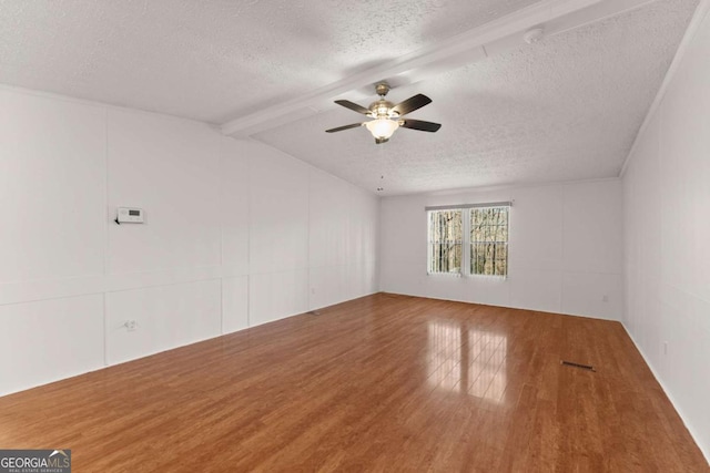 unfurnished room with vaulted ceiling with beams, wood-type flooring, a textured ceiling, and ceiling fan