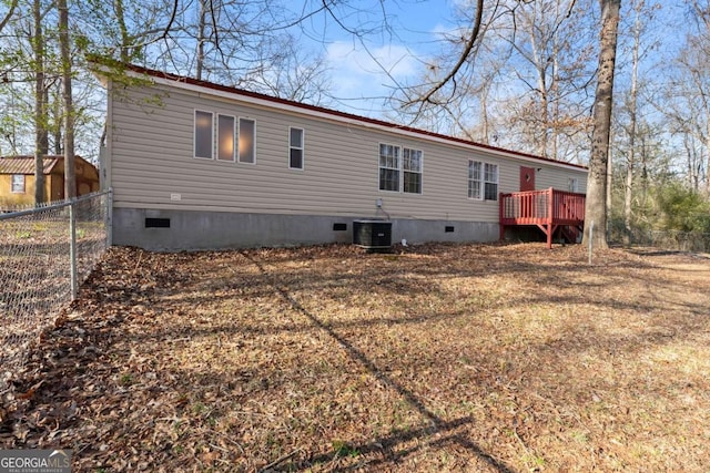 rear view of house featuring a yard, cooling unit, and a deck