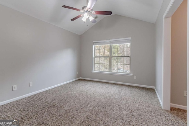 spare room featuring vaulted ceiling, carpet, and ceiling fan