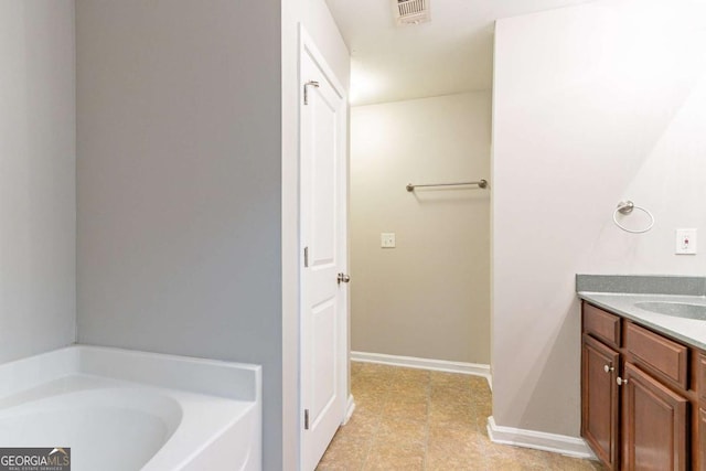 bathroom with vanity and a tub