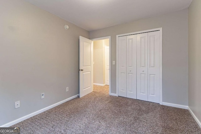 unfurnished bedroom with carpet flooring and a closet