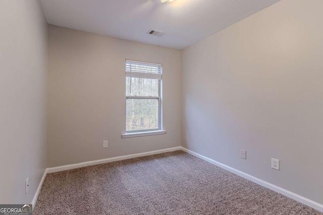 unfurnished room featuring carpet