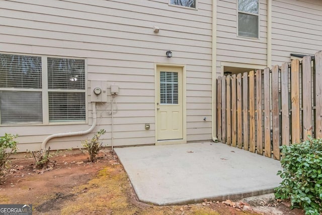 view of exterior entry featuring a patio area