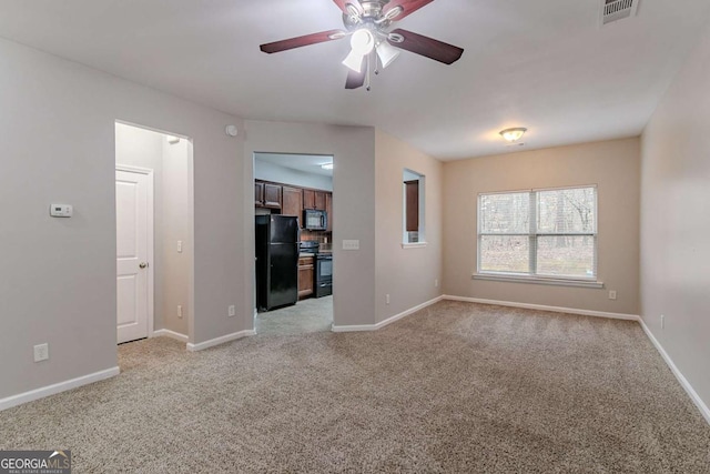 unfurnished room with light colored carpet and ceiling fan