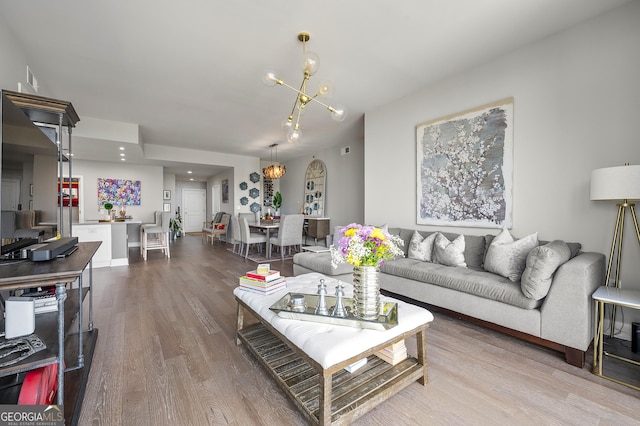 living room with a chandelier and hardwood / wood-style floors