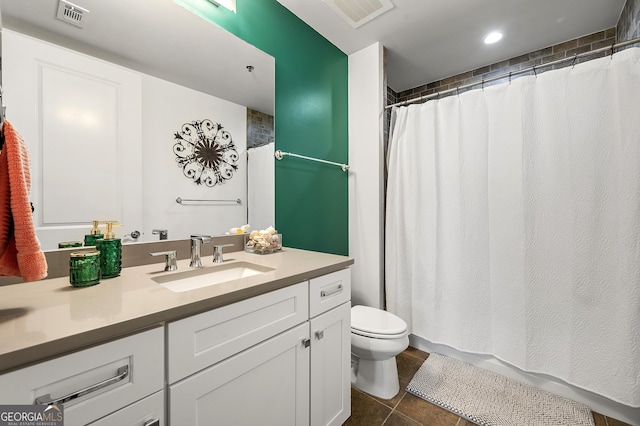 bathroom with tile patterned flooring, vanity, and toilet