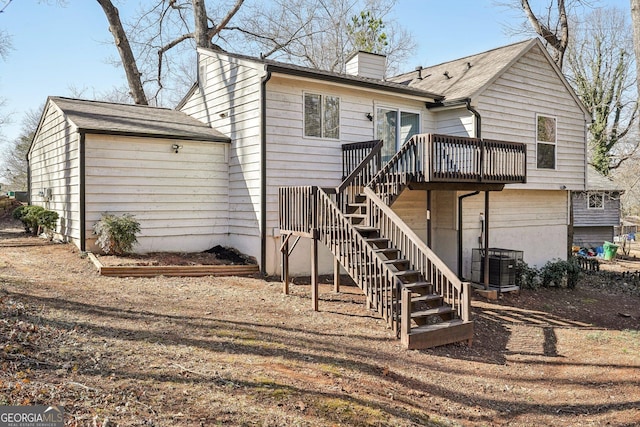 back of property featuring a wooden deck and central AC