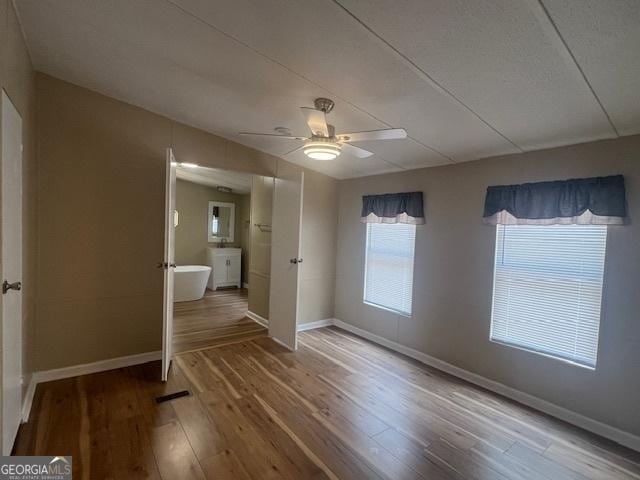 interior space featuring hardwood / wood-style flooring and ceiling fan