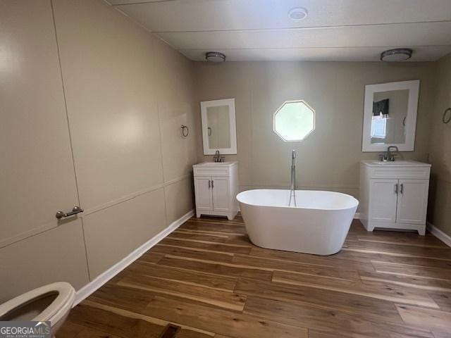 bathroom featuring vanity, hardwood / wood-style floors, and a washtub