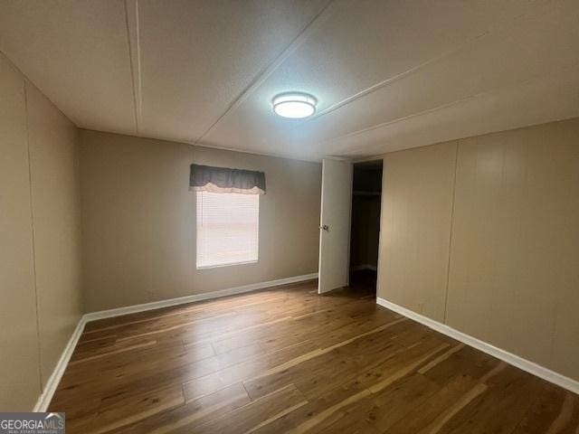 empty room with dark wood-type flooring