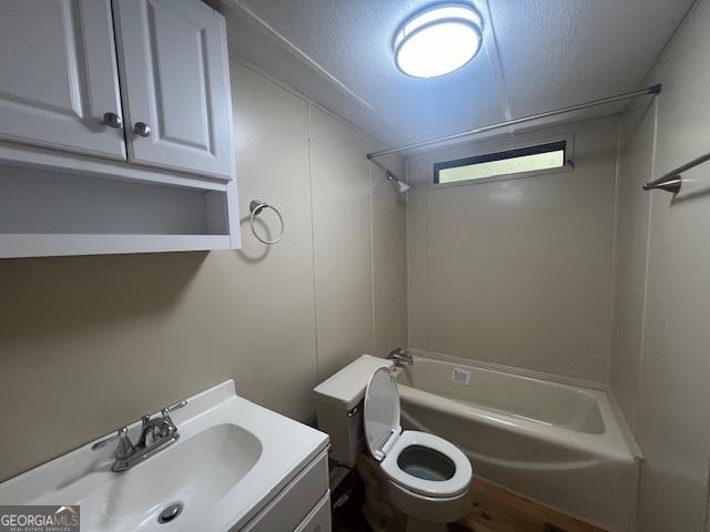 full bathroom with vanity, tub / shower combination, a textured ceiling, and toilet