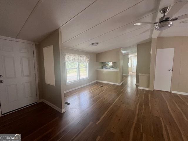 foyer with dark hardwood / wood-style flooring, vaulted ceiling, and ceiling fan