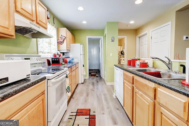 kitchen with sink, light brown cabinetry, white appliances, and light wood-type flooring