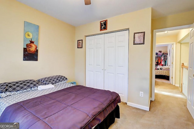 bedroom featuring light carpet, a closet, and ceiling fan