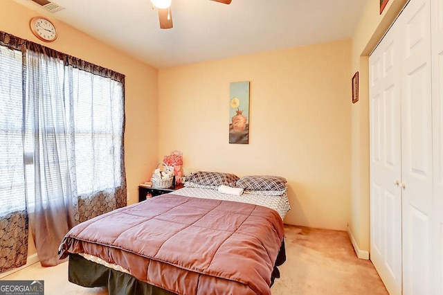 bedroom with multiple windows, light carpet, and ceiling fan