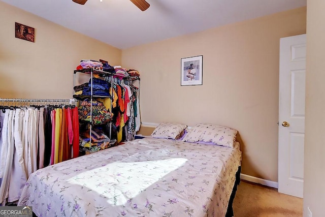 carpeted bedroom featuring ceiling fan and vaulted ceiling