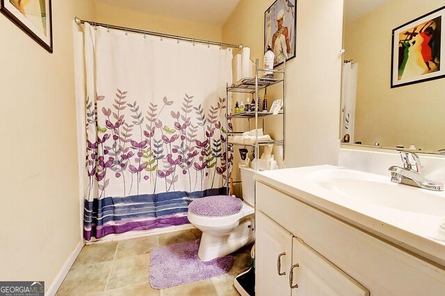 bathroom featuring vanity and toilet