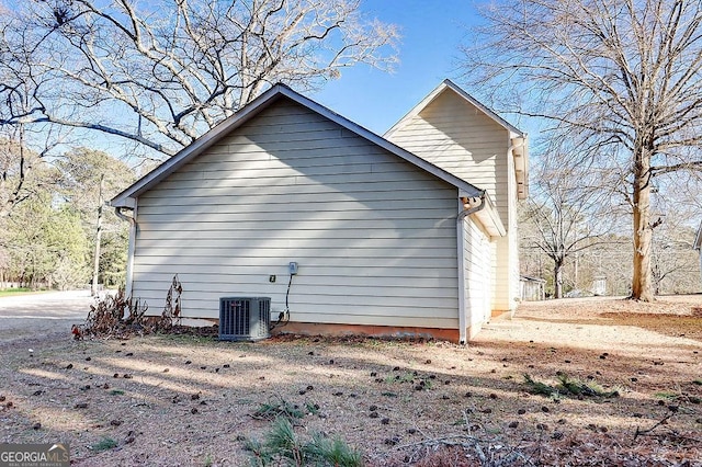 view of side of home with central AC unit