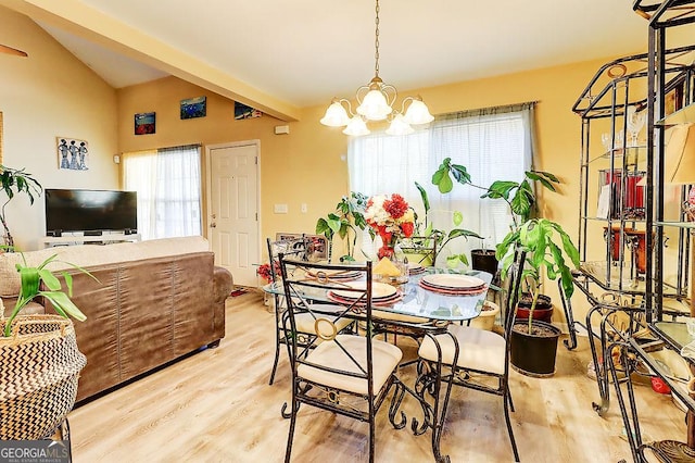 dining space with an inviting chandelier, lofted ceiling, and light wood-type flooring