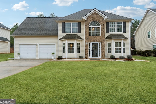 colonial inspired home with concrete driveway, roof with shingles, a garage, and a front yard