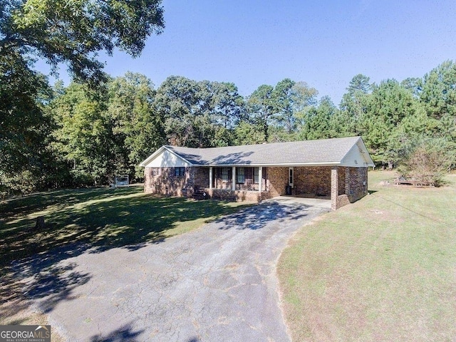 single story home featuring a carport and a front lawn